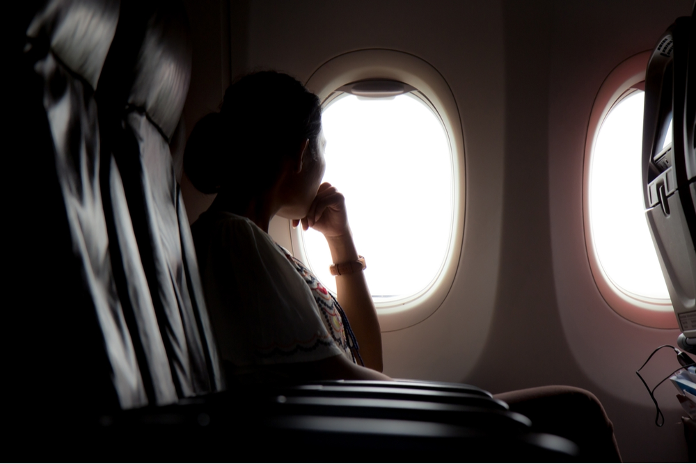 Woman on a plane travelling to out-of-state rehab