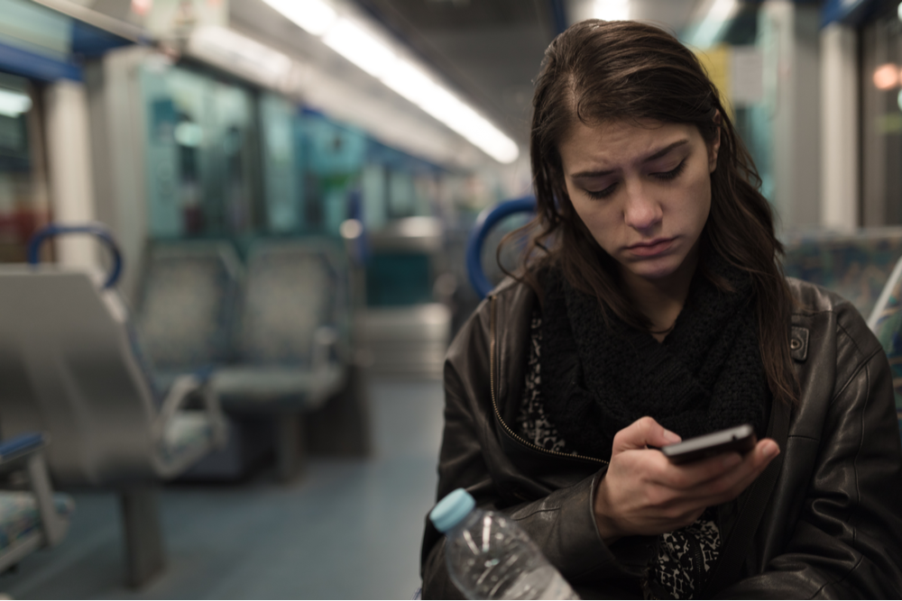 Woman scrolling how to understand trauma on social media
